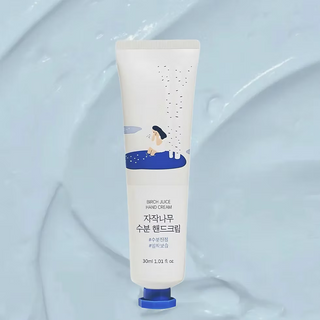Hand cream tube with blue cap on a light blue background